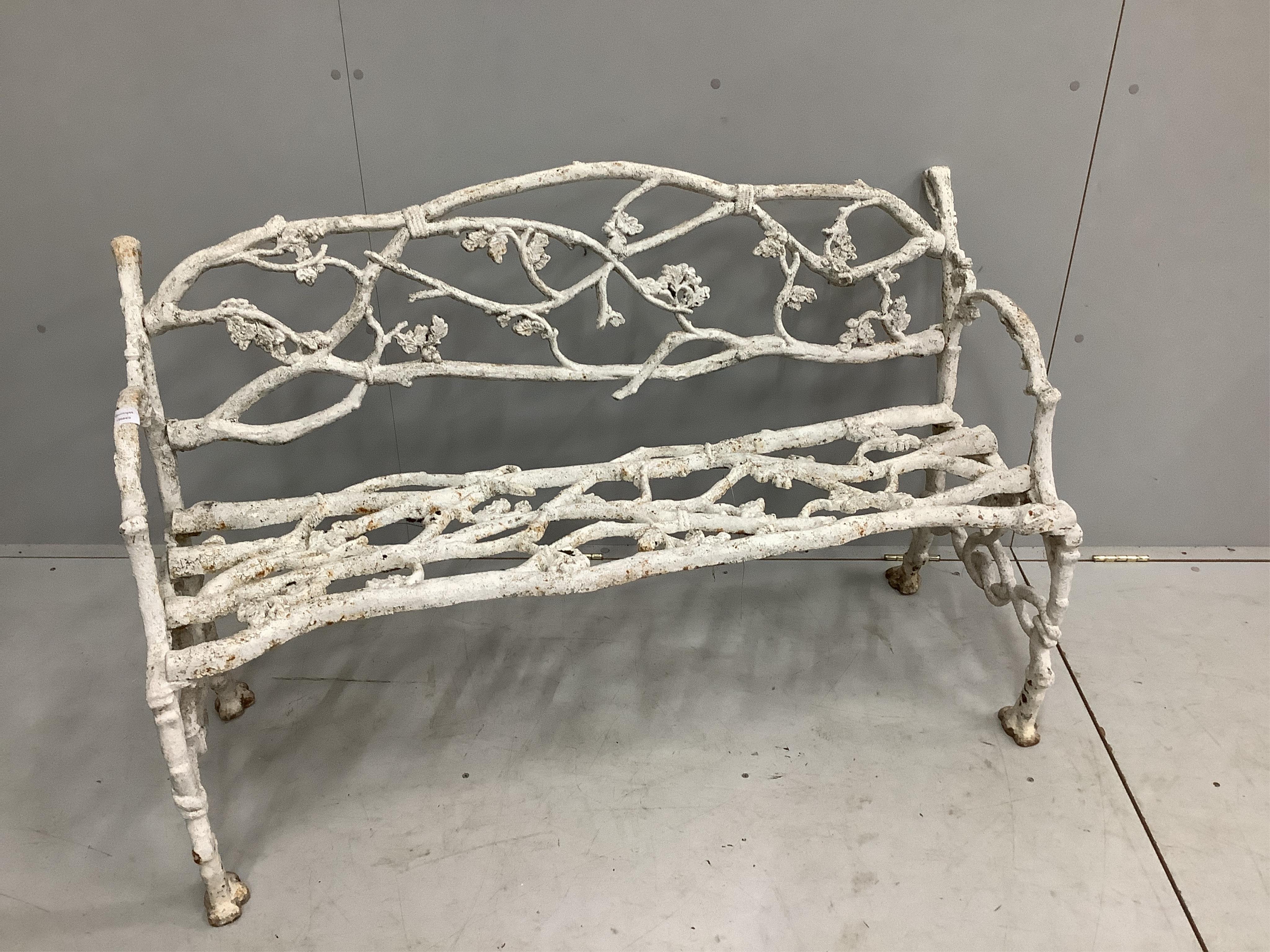 A Victorian Coalbrookdale style cast iron branch pattern garden bench, width 128cm, depth 50cm, height 78cm. Condition - fair